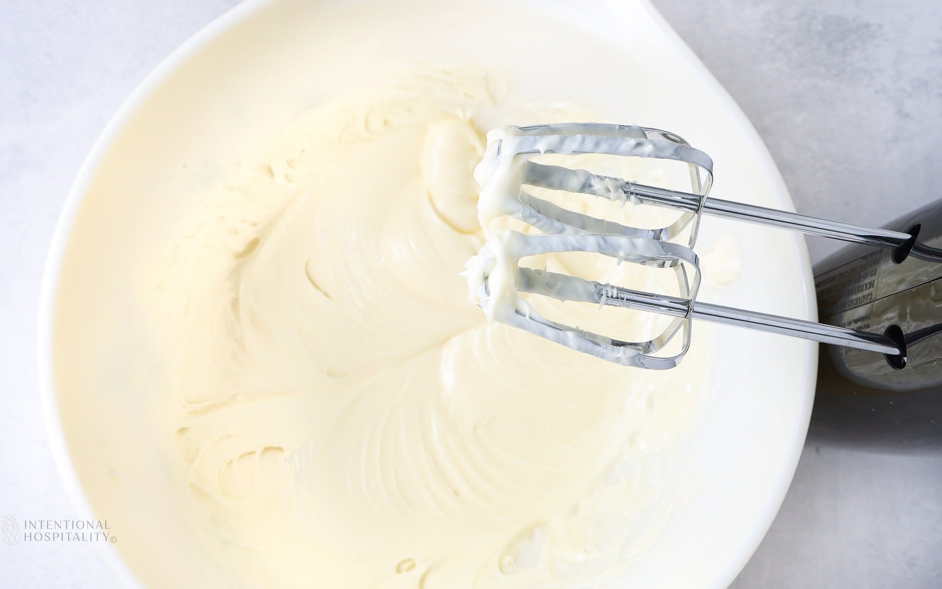 beating cream cheese.