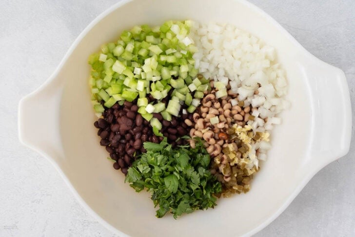 adding vegetables to beans