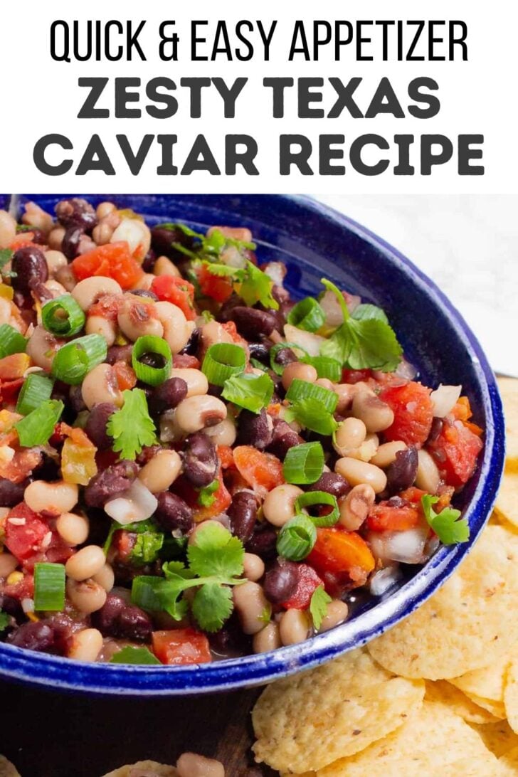 A close-up of a blue bowl filled with Texas caviar, a colorful bean salad with tomatoes, black-eyed peas, black beans, diced peppers, corn, and green onions—perfect alongside tortilla chips. Try adding a twist from your favorite canned cowboy candy recipe!.