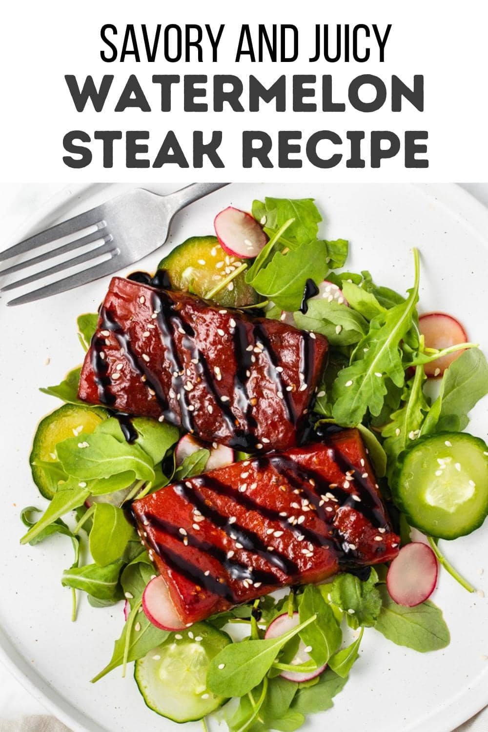 A plate with two rectangular pieces of watermelon steak drizzled with dark sauce, served on a bed of arugula, cucumber, and radish slices. A fork and knife are placed on the side of the plate.