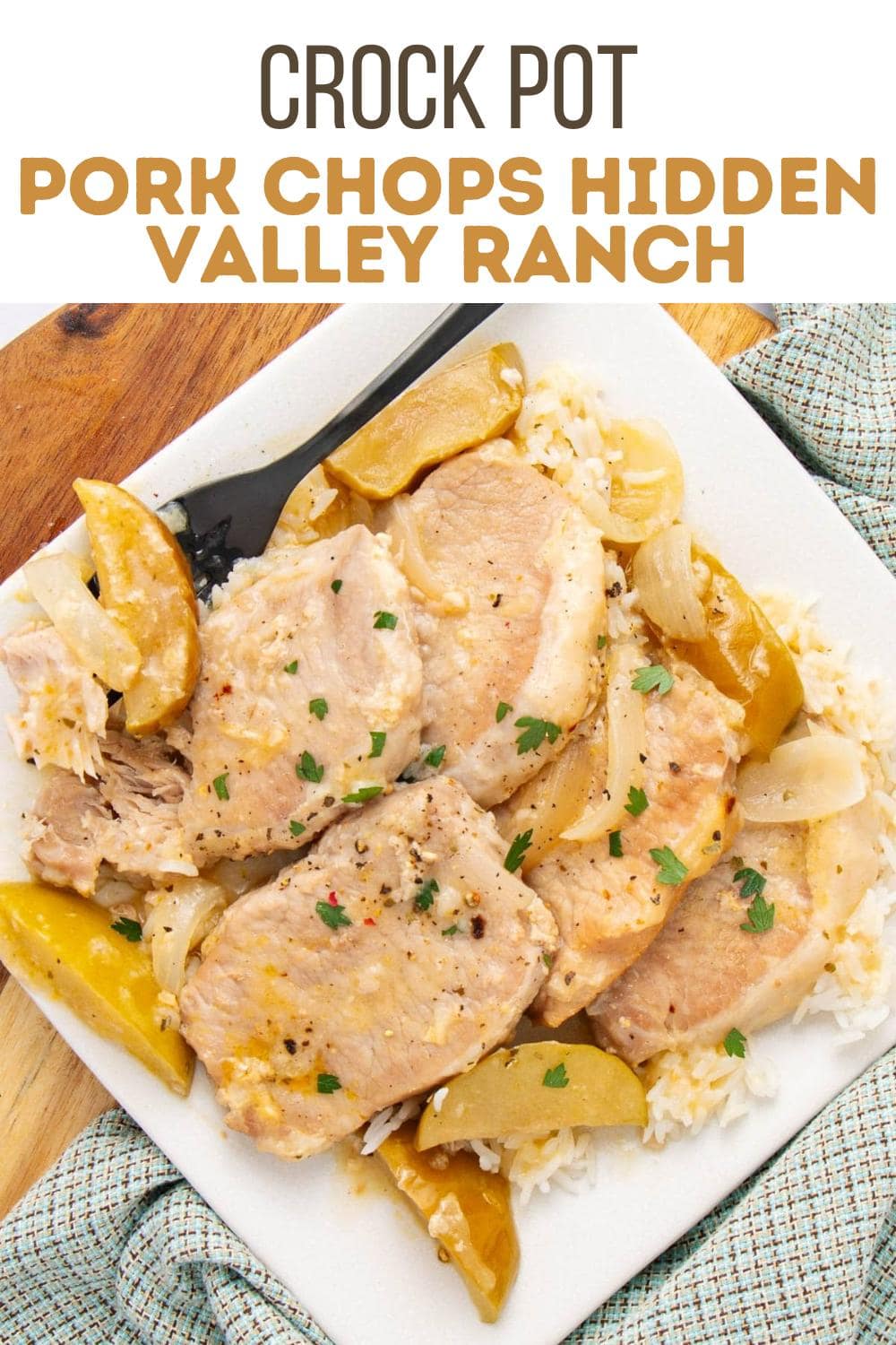 A white plate with cooked pork chops, onions, and apple slices served over rice. The dish is garnished with herbs, and a fork is on the plate. Text above the image reads, "Crock Pot Pork Chops Hidden Valley Ranch.