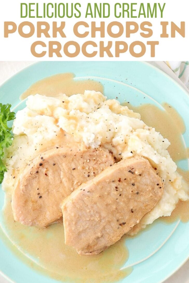 Two pork chops with creamy gravy are served on top of mashed potatoes on a light blue plate, garnished with parsley. Text above reads: "Delicious and creamy pork chops in crockpot.