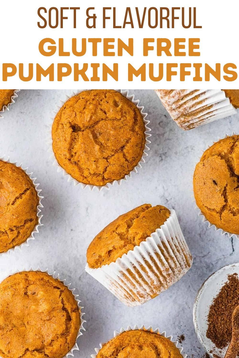 Overhead view of golden-brown gluten free pumpkin muffins in white paper liners arranged on a light surface, with text above reading "Soft & Flavorful Gluten Free Pumpkin Muffins.