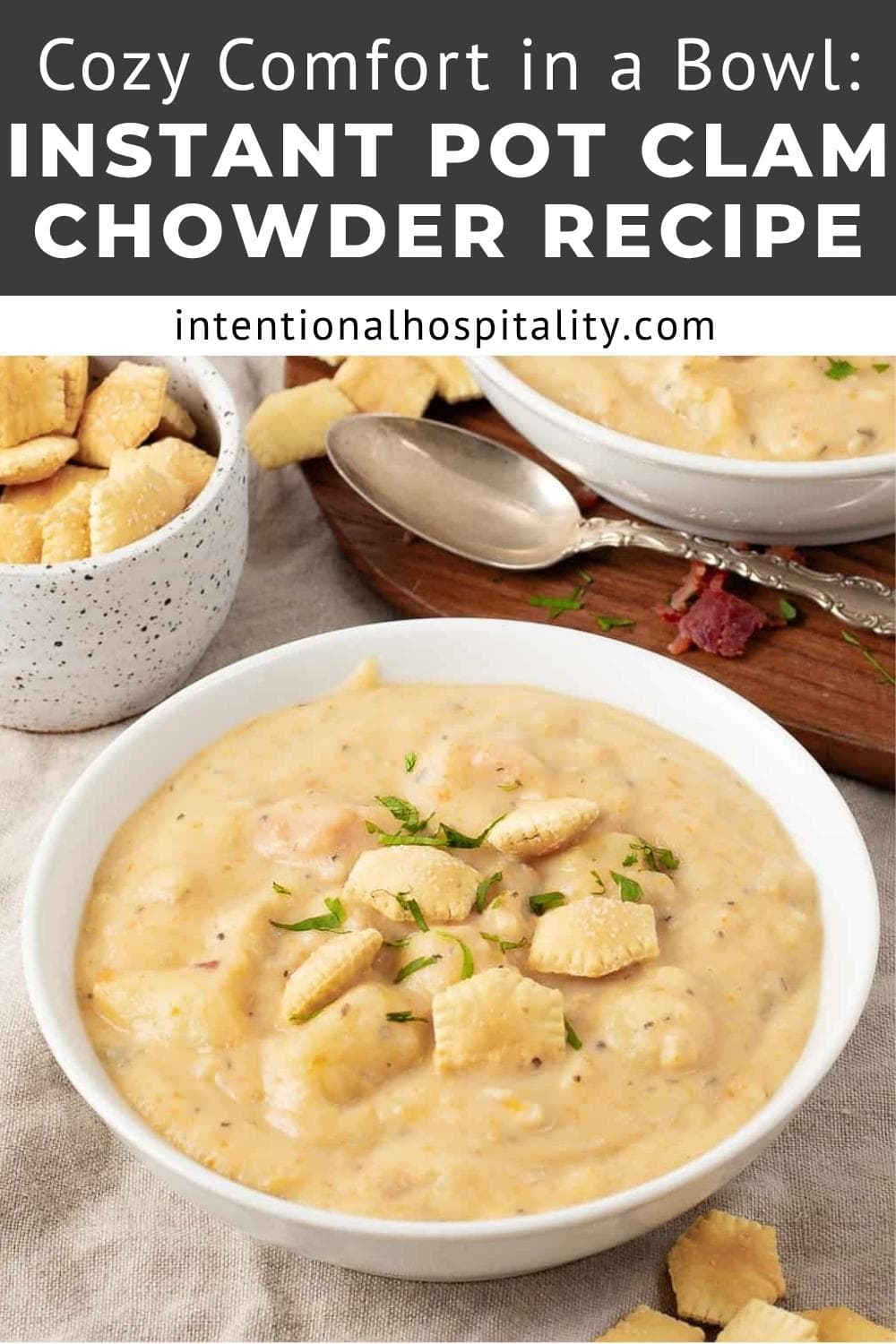 A bowl of creamy clam chowder topped with oyster crackers and herbs, with a spoon beside it. Another bowl of chowder and a bowl of crackers are in the background. Text overlay reads: Instant Pot Clam Chowder Recipe.
