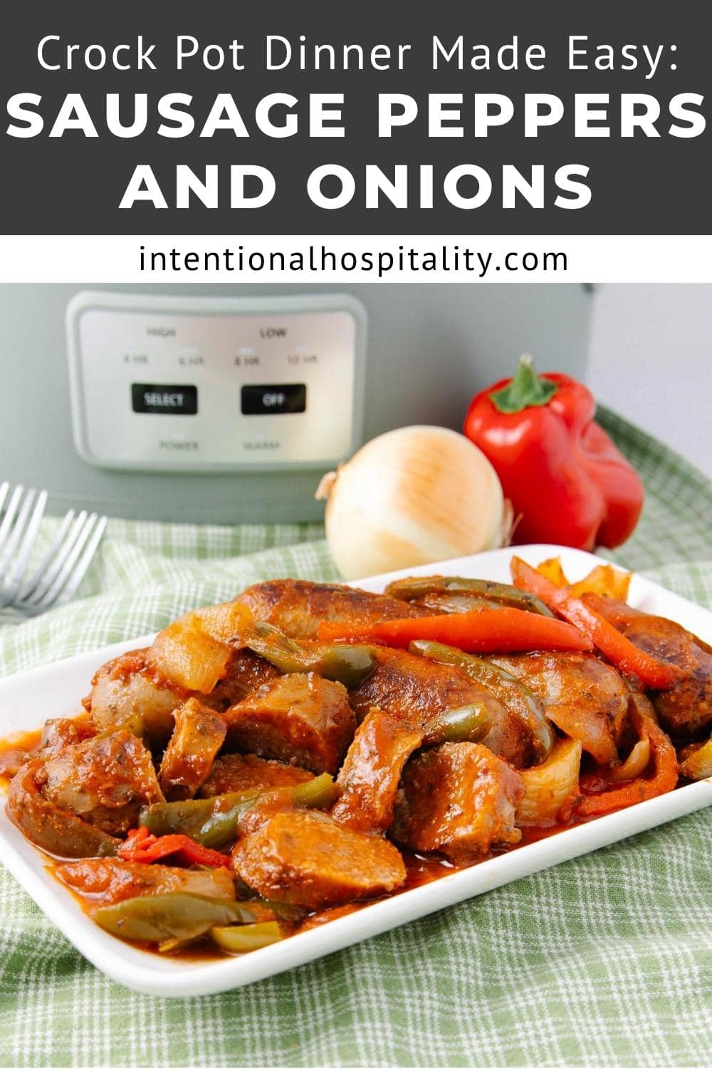 A rectangular white plate filled with cooked sausage, red peppers, and onions sits in front of a slow cooker, with a whole onion and red bell pepper in the background. Text above reads: "Crock Pot Dinner Made Easy: Sausage Peppers and Onions.