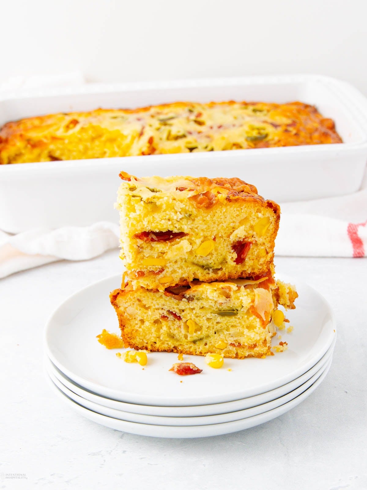 A stack of cornbread on plates.
