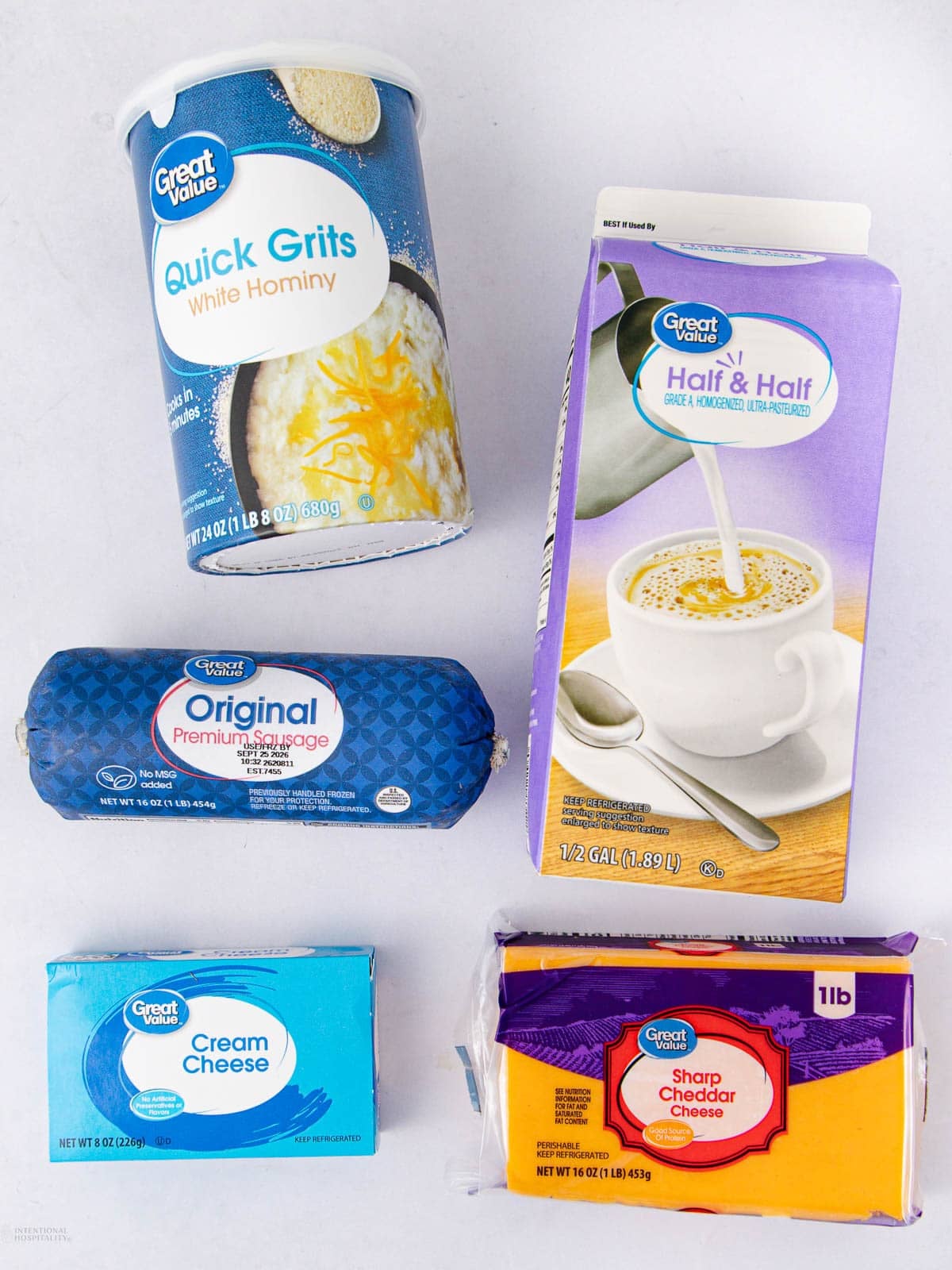 Five Great Value brand products: quick grits, half & half, original premium sausage, cream cheese, and sharp cheddar cheese, arranged on a white surface.